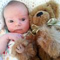 Baby grandson cuddling Emil Teddy Bear